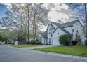 Traditional home with manicured lawn, two-car garage, and classic architectural details at 203 Candleberry Cir, Goose Creek, SC 29445