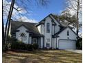 Charming two-story home featuring white siding, a dark roof, well-maintained landscaping and attached garage at 203 Candleberry Cir, Goose Creek, SC 29445