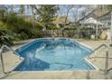 Inviting in-ground pool with clear blue water, surrounded by a concrete patio at 203 Candleberry Cir, Goose Creek, SC 29445