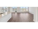 Open concept living room with luxury vinyl floors, large windows, and access to the water at 217 Denham St, Summerville, SC 29486