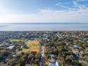 Expansive aerial view shows beach homes near the ocean and recreational fields at 29 27Th Ave, Isle of Palms, SC 29451