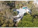 Aerial view of a home with a backyard deck and in-ground pool surrounded by lush greenery at 29 27Th Ave, Isle of Palms, SC 29451