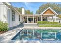 Gorgeous backyard with a modern pool, spa, an outdoor pavilion, and multiple seating areas at 299 Bampfield Dr, Mount Pleasant, SC 29464