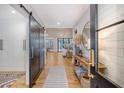 Inviting entryway featuring a sliding barn door, light hardwood floors, and a glimpse of the living room at 299 Bampfield Dr, Mount Pleasant, SC 29464