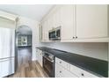 Renovated kitchen featuring stainless steel appliances, white cabinetry, and sleek countertop and open floorplan at 3274 Heathland Way, Mount Pleasant, SC 29466