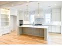 Modern kitchen features custom cabinets, a large island, and stylish pendant lighting at 3853 Delinger Dr, Mount Pleasant, SC 29466