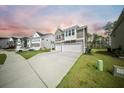 Attractive two-story home with a two-car garage, complemented by a green lawn and sidewalk at 436 Rowley Ln, Summerville, SC 29486