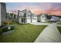 Stylish two-story home showcasing neutral siding, a two-car garage, and lush green landscaping at 436 Rowley Ln, Summerville, SC 29486