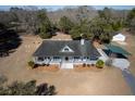 Spacious property with a well-kept house, detached garage, carport, and expansive lawn at 6118 Hazelhurst Ln, Ravenel, SC 29470