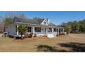 Well-maintained home featuring a cozy front porch with seating and attractive exterior details at 6118 Hazelhurst Ln, Ravenel, SC 29470
