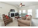 Bright living area featuring fireplace, high ceilings, ceiling fan and comfortable couches and chairs at 613 Zinnia Dr, Goose Creek, SC 29445