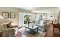 Cozy living room with large windows, plantation shutters and hardwood floors, creating a relaxing atmosphere at 747 Spinnaker Beachhouse, Seabrook Island, SC 29455