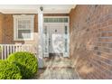 Close-up of the elegant front door with decorative glass and well-maintained brick facade at 779 Hamlet Cir, Goose Creek, SC 29445