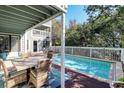 A lovely back yard pool is situated next to the home's outside dining area and spiraling staircase at 8 Fairway Oaks Ln, Isle of Palms, SC 29451