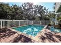 Inviting in-ground pool surrounded by a wood deck and white fence, perfect for relaxation at 8 Fairway Oaks Ln, Isle of Palms, SC 29451