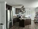 Modern kitchen featuring dark cabinetry, stainless steel appliances, and a center island at 8072 Bing Hill Road Rd, Adams Run, SC 29426