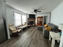 Comfortable living room featuring wood laminate floors and a brick fireplace at 8072 Bing Hill Road Rd, Adams Run, SC 29426