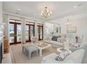 Bright living room featuring elegant furnishings, hardwood floors, and French doors with scenic views at 821 Bulls Bay Blvd, Mount Pleasant, SC 29429