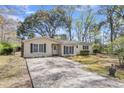 Well-kept single-story home with an expansive driveway and traditional architecture at 834 Prince John Dr, Charleston, SC 29407