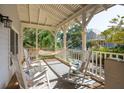 Inviting front porch featuring rocking chairs and a hammock, perfect for relaxing outdoors at 94 Seaside Cottage Ln, Isle of Palms, SC 29451