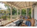 Inviting covered porch furnished with comfortable wicker seating, creating a cozy outdoor space at 94 Seaside Cottage Ln, Isle of Palms, SC 29451