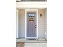 Charming front door features a welcoming wreath, modern lighting, and neutral tones at 9402 Sweep Dr, Summerville, SC 29485
