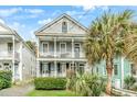 Charming two-story home with double porches, well-manicured landscaping and a beautiful palm tree at 318 Sumter St, Charleston, SC 29403