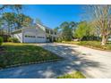 View of the long driveway leading to a two-story home with an attached two car garage at 102 Challis Ct, Goose Creek, SC 29445