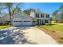 Home's well maintained lawn and landscaping leading up to the house and attached two car garage at 102 Challis Ct, Goose Creek, SC 29445