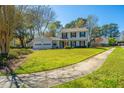 Charming two-story home with a well-maintained lawn and sidewalk at 102 Challis Ct, Goose Creek, SC 29445