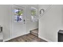 Inviting entryway with a white door, a sidelight window, light walls, and hardwood flooring at 1032 Berry Patch Cir, Summerville, SC 29485