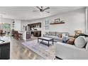 Open-concept living room featuring modern furniture, a ceiling fan, and hardwood flooring at 1032 Berry Patch Cir, Summerville, SC 29485