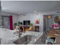 Stylish kitchen with granite counters, modern faucet, and a view of the living and dining areas at 1054 Anna Knapp Blvd # 4E, Mount Pleasant, SC 29464