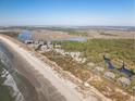 Scenic aerial view showcases the beachside homes and a path that leads to the shore at 1109 Diodia Ct, Kiawah Island, SC 29455