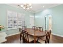 Bright dining room with wood floors, plantation shutters, and classic decor at 112 Etiwan Park St, Charleston, SC 29492