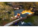 Aerial view of a cozy home with a pool and wooden deck in a leafy neighborhood at 1235 Sunset Dr, Charleston, SC 29407