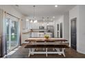 Bright dining area with sliding glass door and open concept kitchen with stainless steel appliances at 133 Caleb Ct, Ladson, SC 29456