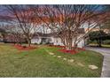 Charming brick home featuring landscaped yard with mature trees and stone pathway at 1522 N Pinebark Ln, Charleston, SC 29407