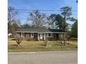 Charming brick ranch home with a covered entrance and well-maintained front yard, ready for new owners at 161 Palm St, Walterboro, SC 29488