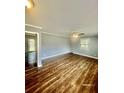 Bright living room with modern wood flooring, neutral paint, white trim, and a ceiling fan for added comfort at 161 Palm St, Walterboro, SC 29488