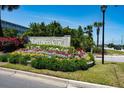 Mariners Cay entrance sign surrounded by colorful flowers and lush greenery, a vibrant community welcome at 2 Mcdonough Rd # C-1, Folly Beach, SC 29439