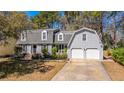 Inviting two-story home with a gray exterior, dormer windows, and an attached two-car garage at 202 Hunt Club Dr, Summerville, SC 29485