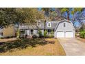 Beautiful two-story home featuring an attached two-car garage, lush landscaping, and a classic design at 202 Hunt Club Dr, Summerville, SC 29485