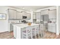 Bright kitchen features stainless appliances, center island with seating and stylish gray cabinets at 204 Belfort Pl, Summerville, SC 29486