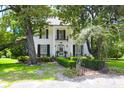 Beautiful two-story home with a brick path, mature trees, and well-maintained landscaping at 219 Rigby St, Reevesville, SC 29471