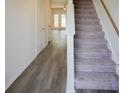 Bright hallway showcasing hardwood floors, a staircase with carpet, and white trim at 232 Buchanan Cir, Goose Creek, SC 29445