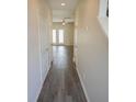 Clean, bright hallway with hardwood floors leading to a room with French doors and lots of natural light at 232 Buchanan Cir, Goose Creek, SC 29445