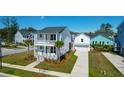 Two-story home featuring double porches, palm trees, driveway, and a detached garage at 2461 Lieutenant Dozier Dr, Johns Island, SC 29455