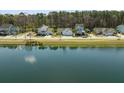 Beautiful aerial view of a neighborhood with houses surrounding a lake and lush green trees at 2620 Private Lefler Dr, Johns Island, SC 29455