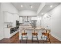 Modern kitchen with white cabinets, granite countertops, stainless steel appliances, and a breakfast bar at 2620 Private Lefler Dr, Johns Island, SC 29455